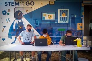 Students engaging with the STEM-on-the-Go van
